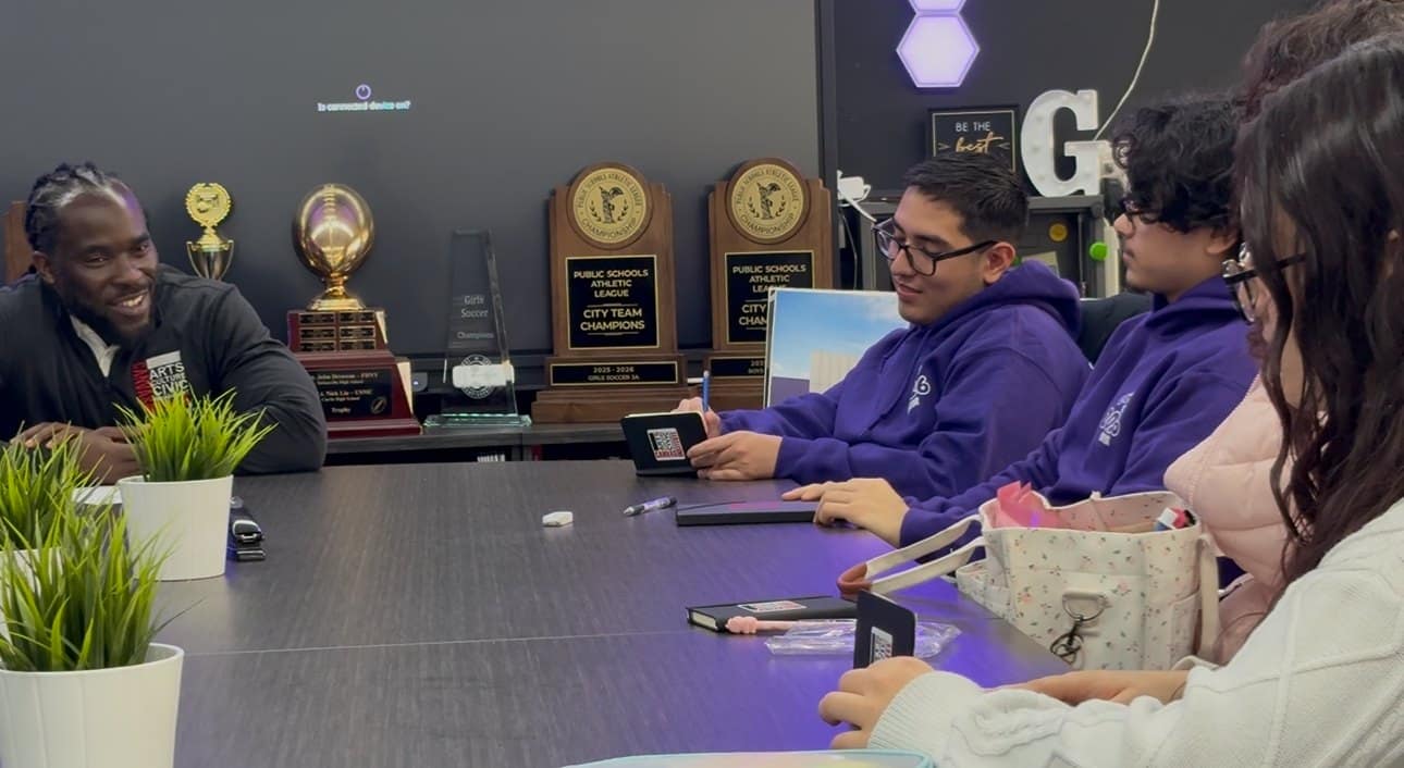 A facilitator meets with students in a school office during a small-group session.