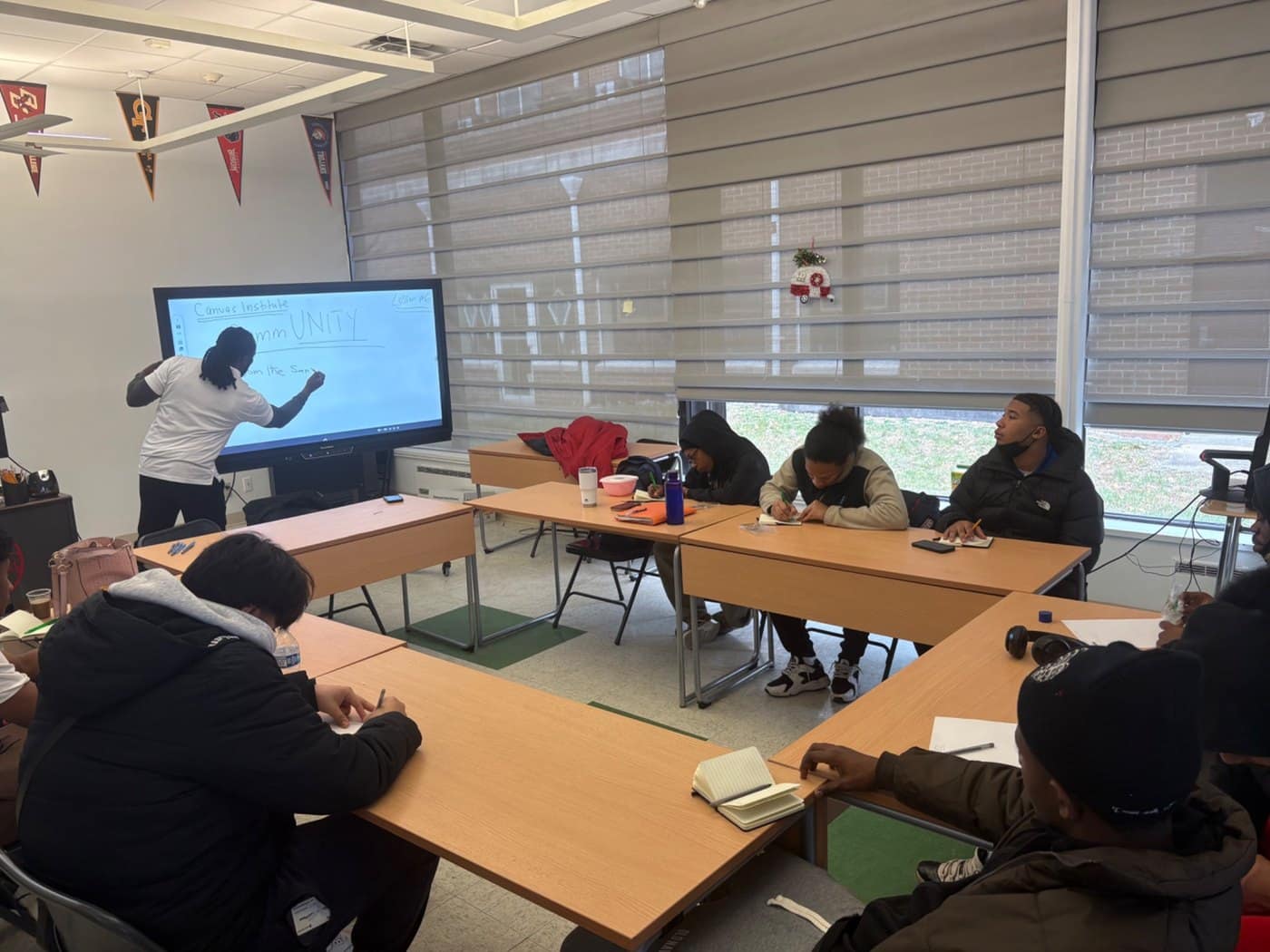 Students participate in a classroom lesson led at an interactive display.