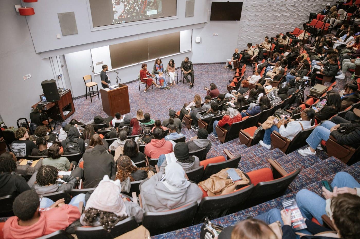 A large audience fills an auditorium during the 19th Annual Youth Empowerment Summit.